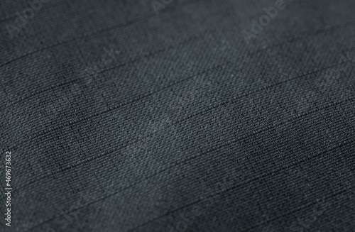 macro black ripstop, polyester or nylon fabric textured background closeup