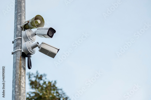 Two security cameras and loudspeaker on a metal post. Safety industry concept. Modern surveillance concept.