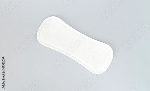 Natural daily sanitary pad or pantyliner top view on gray background