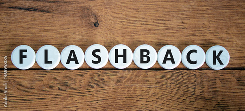 Flashback symbol. The concept word Flashback on white circles. Beautiful wooden table, wooden background. Business and flashback concept. Copy space.
