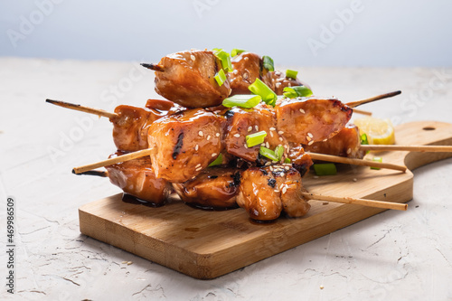 Chicken fillet yakitori close-up. Delicious chicken pieces on skewers cooked on the grill. Asian style.