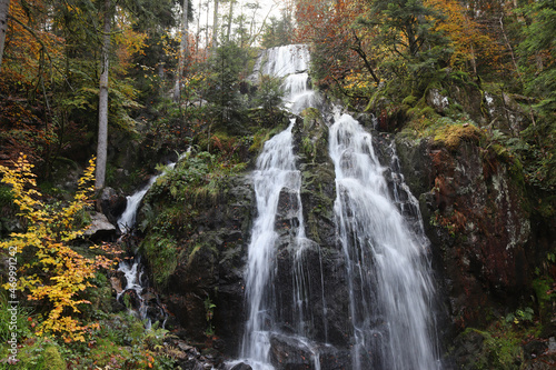 The beautiful 32m high Grande Cascade de Tendon, in autumn. The three-tiered waterfall is a scenic tourist attraction in the Haut Vosges area of eastern France.