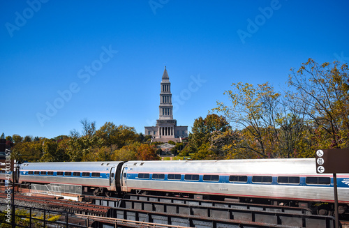 Alexandria, Virginia, USA - November 1, 2021: King Street - Old Town WMATA Metro Station, looking at the George Washington Masonic Temple, with an Amtrak Train in the Foreground on a Fall Afternoon