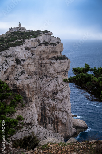 Capo Caccia lighthouse. Lighthouse on high rocky cliff next to the ocean in Sardinia Italy. 