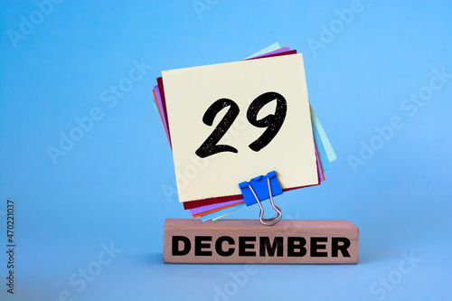 December 29th. Day 29 of December month, calendar on workplace with blue background. Winter time. 