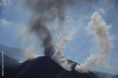 Erupting volcano, clouds of steam, ash and blue sky in the background, La Palma, Canary Islands