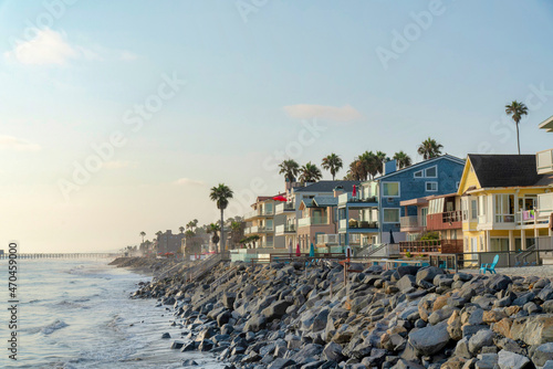 Oceanside beach houses in California with stairs on the natural rock seawall