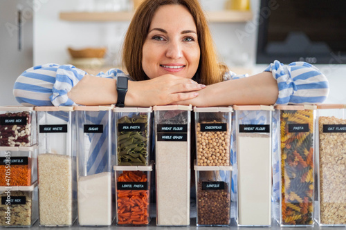 Woman professional space organizer smiling posing with case boxes for comfortable product storage