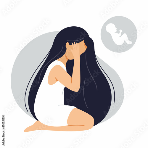 Young woman is sitting on floor and crying. Infertility, miscarriage and pregnancy problems. Women health.