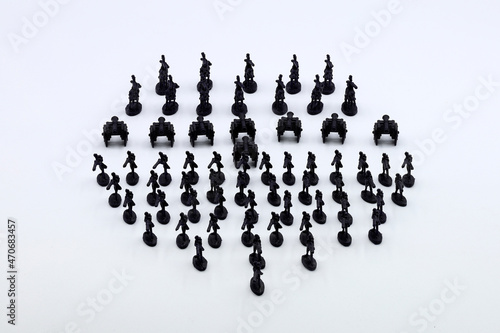 regiment of black plastic soldiers on white background