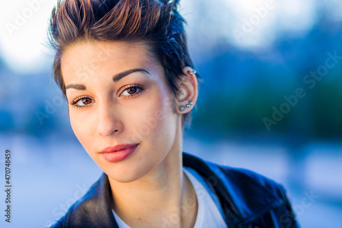 headshot froma a yooung hispanic female. Beautiful woman with an ambiguous hairsyling