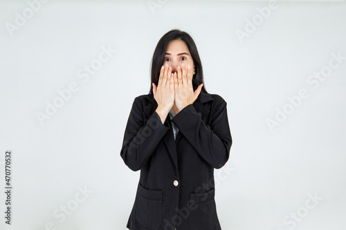 Frightened Asian woman on black jacket outfit of business professional cover mouth as surprised and scared on unintentional bad news that unexpected happen