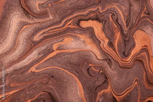 Abstract fluid art background dark brown and bronze colors. Liquid marble. Acrylic painting with umber gradient.