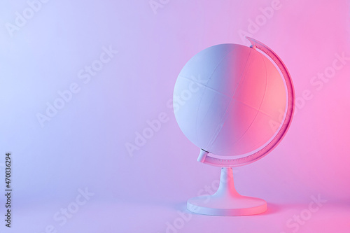 Model of a globe with blank map in pink light