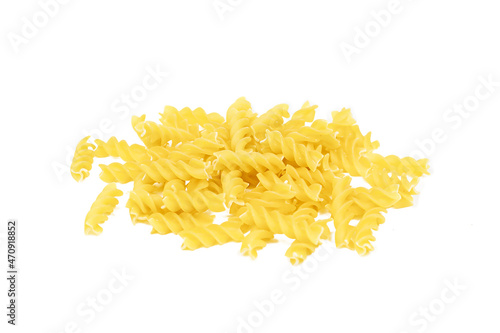 Yellow uncooked fusilli pasta heap isolated on white background.