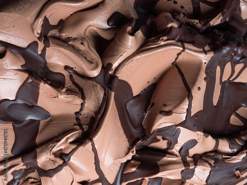 Chocolate flavour gelato - full frame detail. Close up of a brown surface texture of chocolate Ice cream covered with dark chocolate topping.