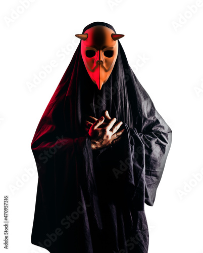 Isolated scary horror occult sectarian priest in black hood and metal mask on white background.