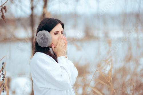Woman Warming Her Hands During Cold Winter Season