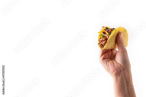 Hand holding traditional Mexican tacos with meat and vegetables isolated on white background