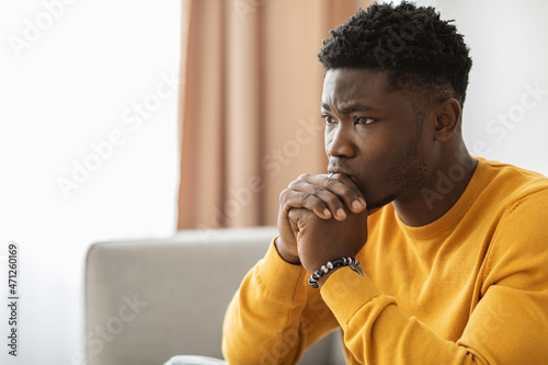 Pensive african american guy having headache, closeup portrait