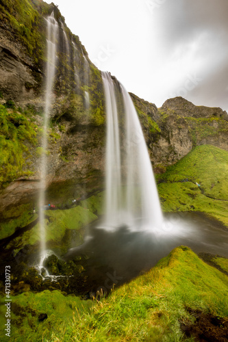 Seljalandsfoss, Southern Iceland. Long exposure photograph of the famous waterfall, a tourist destination. Moody summer day
