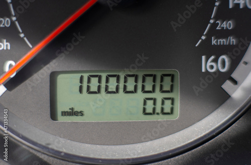 A car odometer with 100,000 miles 