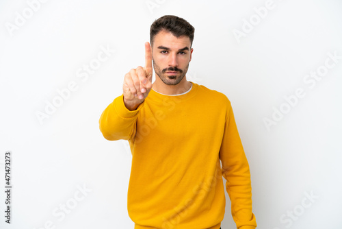 Young caucasian man isolated on white background counting one with serious expression