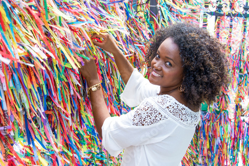 Portrait of a model smiling against colorful background.