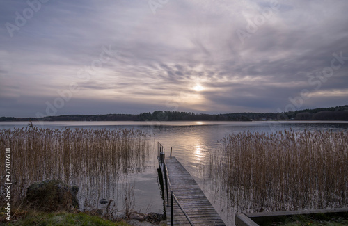 A jetty in the lake Mälaren surrounded with reeds a Pale Winter solstice day in the district Bromma in Stockholm