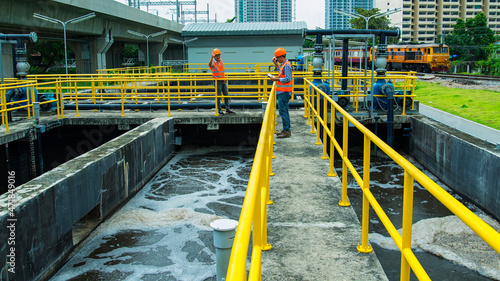 service engineer checking on waste water treatment plant with pump on background. worker working on Waste water plant.