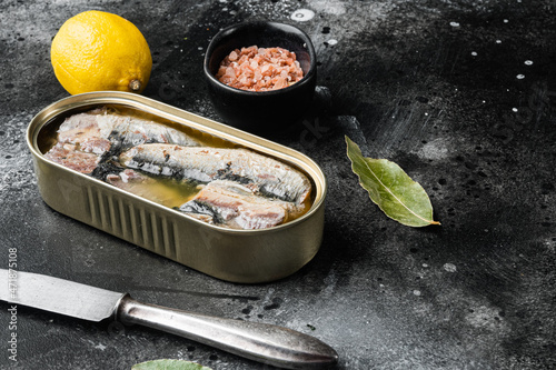 Sardines can preserve, on black dark stone table background, with copy space for text