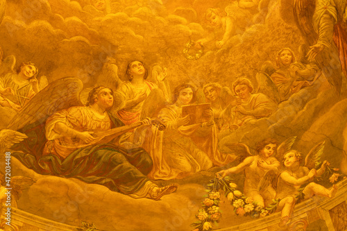 FORLÍ, ITALY - NOVEMBER 11, 2021: The fresco of angels with the music instruments in cupola of Cattedrala di Santa Croce by Giovanni Secchi (1876 - 1950).