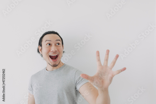 Excited and wow face of Asian man proud to present advertisement.