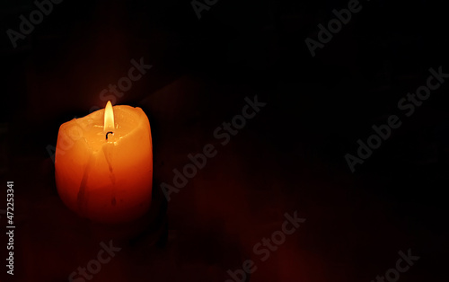 Funeral candle flame candlelight on dark background