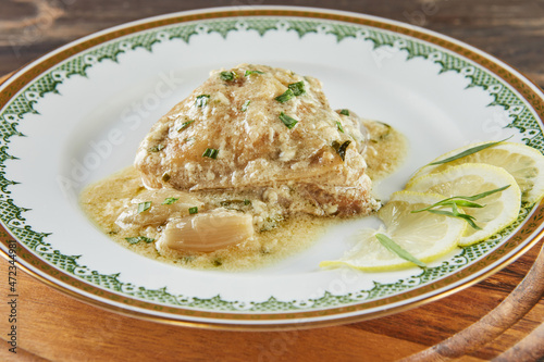 Chicken in tarragon with mustard and pearl onions. French gourmet cuisine