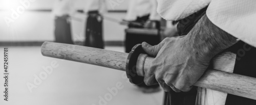 Person practicing aikido martial art in a dojo background.