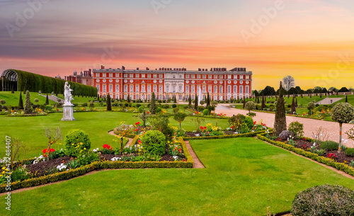 Hampton Court palace and gardens at sunset, London, UK