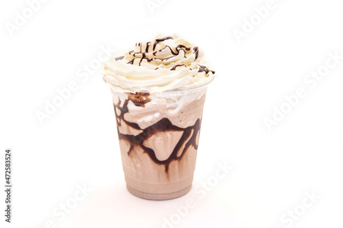 Mocha flavoured frappe served in a plastic cup with whipped cream with drizzling chocolate syrup.