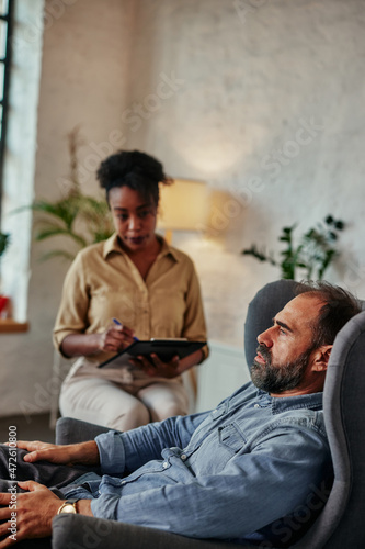 Male client having consultation with psychologist