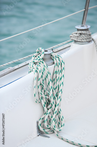 Winch and nautical ropes on a sailing boat in the port