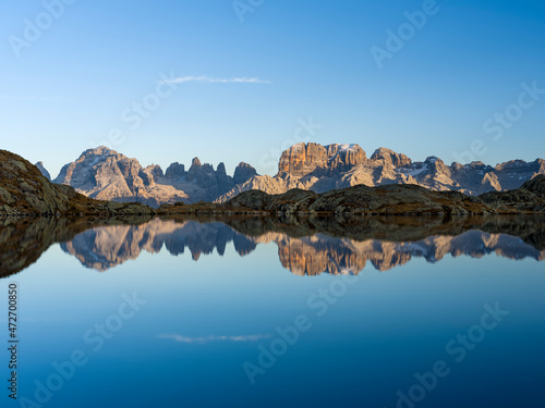 The summits of Brenta mountain range are reflected in Lago Nero. Brenta group in the Dolomites, part of UNESCO. Europe, Italy, Val Rendena