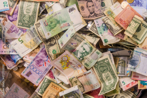 International foreign currency bills and coins in the donations box at Notre Dame Cathedral, Paris, France.