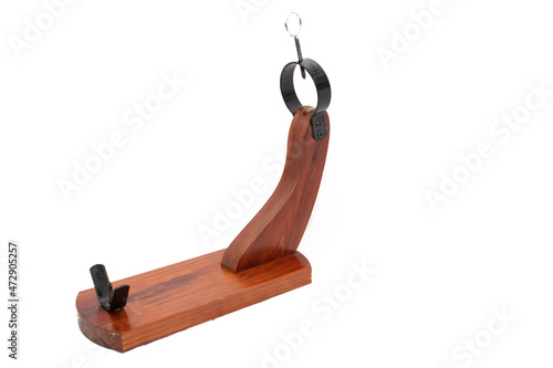 A wooden serrano ham holder, isolated on white background.