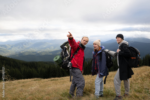 Hiking in the mountains, a group of tourists with backpacks looking into the distance, Montenegrin ridge, natural landscape adventure in nature