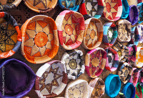 Colourful leather handcraft bowl shaped souvenirs displayed at traditional souk - typical street in Morocco
