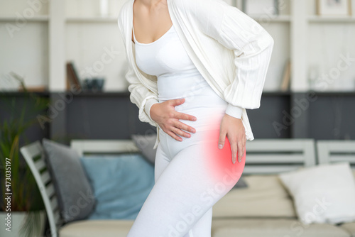 Hip pain, woman suffering from osteoarthritis at home, health problems concept