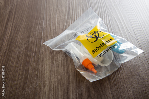 Covid-19 Rapid Antigen Test kit and biohazard specimen bag. Concept of waste separation