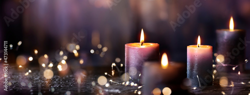 Advent Candles - Four Purple Votive Candlelight In Church With Defocused Abstract Lights