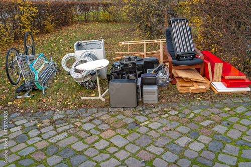 Pile of home bulky waste prepared for pickup at the street in German city.