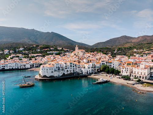 Drone shot Santa Maria de Cadaqués Drone view of a small village on the Costa Brava in Cadaqués. Boats in a rocky bay in Cadaques. View from the drone of the beach and the bay in Cadaques. 